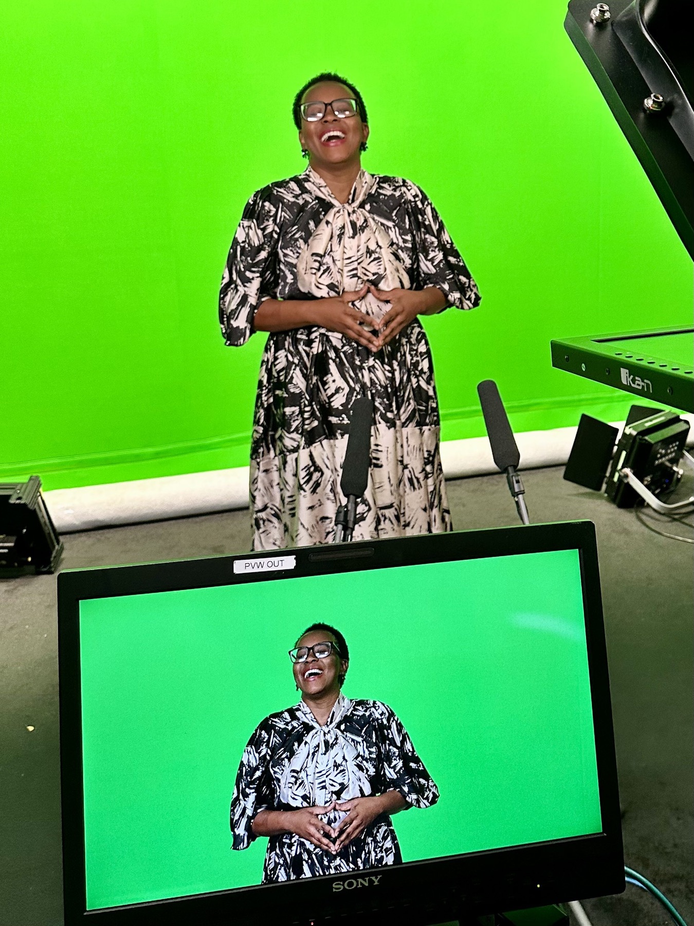 An interview contributor laughing naturally on a green-screen set during a London Business School production