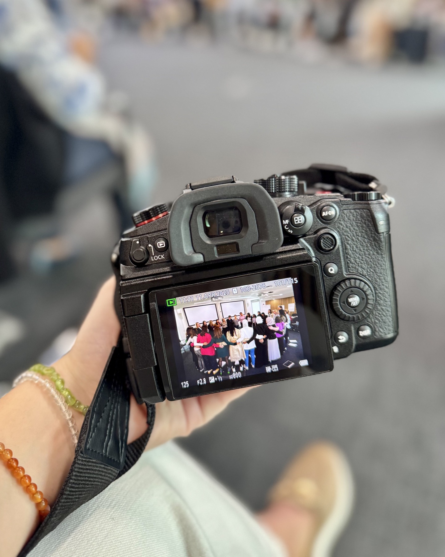A camera screen showing London Business School participants standing together during a live session